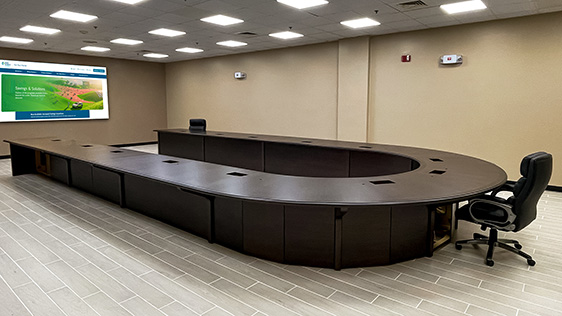 U shape conference table fully assembled onsite in client's room with AV integration facing TV media
