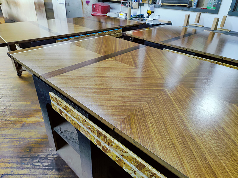 Intricate wood pattern boat conference table with sophisticated AV integration