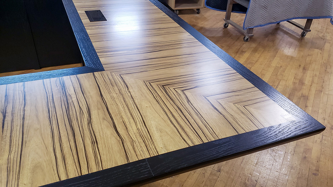 U shape conference table close up photo of edge profile, AV integration, wood pairing and seamless veneer