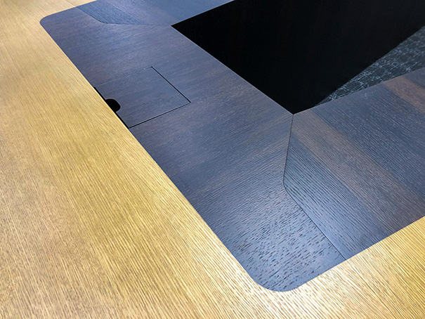U shape conference table detailed photo capturing wood grain, color pairing, and AV integration